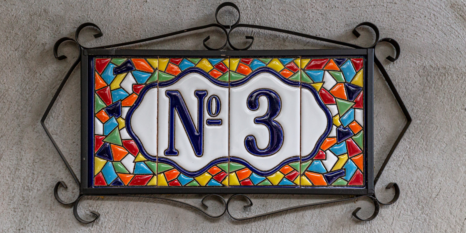 A mosaic door number tile with a number 3.